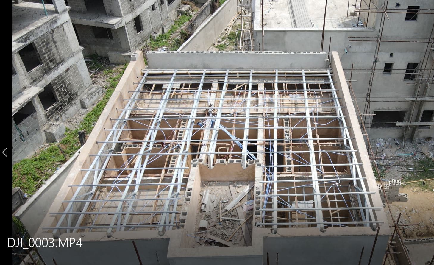 Drone aerial view of construction site with steel roof framework